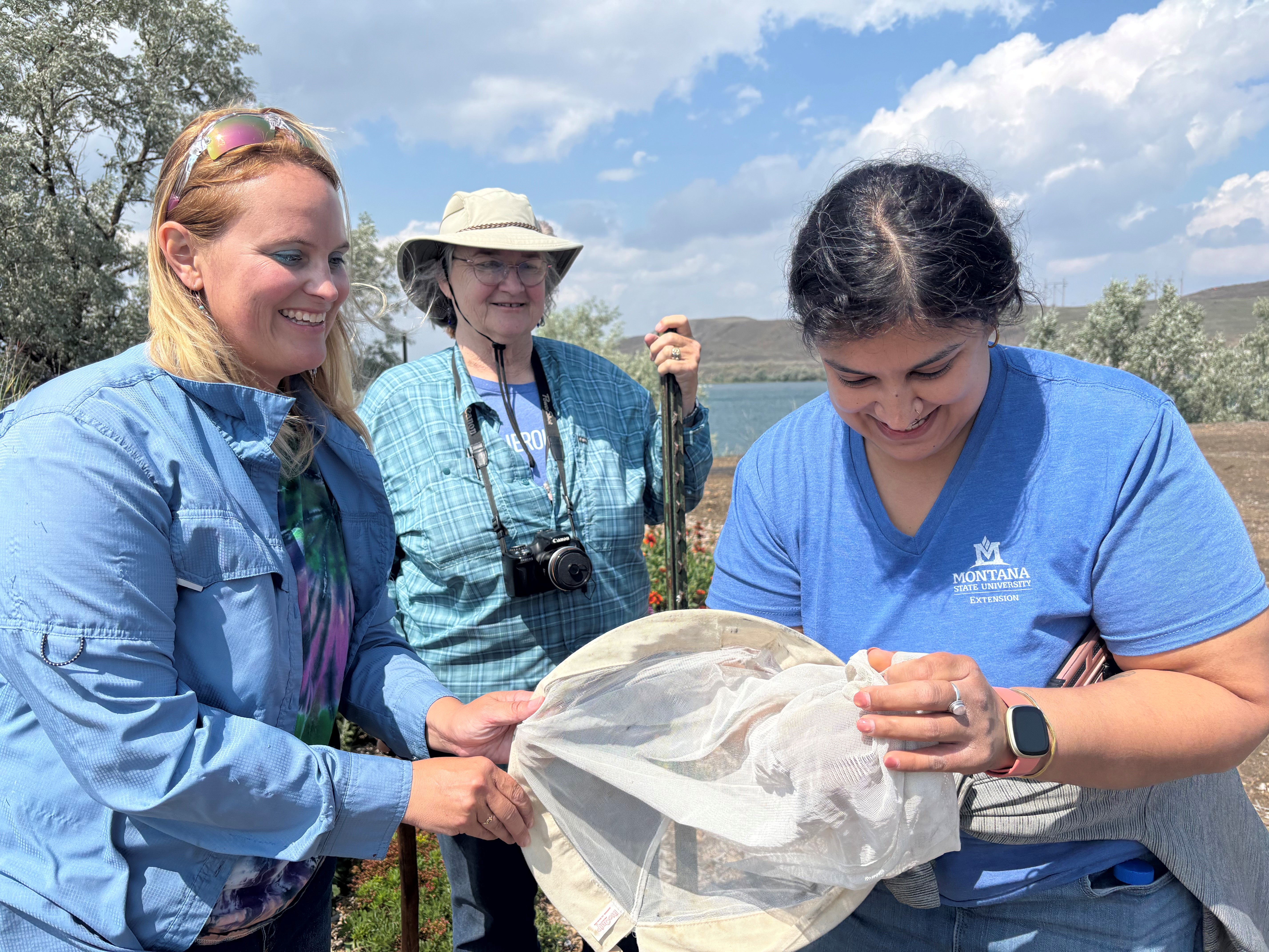 Abi Saeed (right) demonstrates proper insect collection techniques to Katie Busch (left) and Linda Sibley (middle).